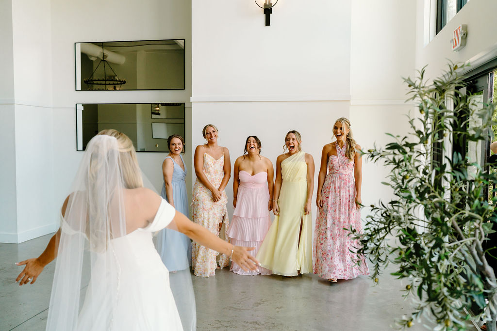 Bride Sharing First Look with Wedding Party Southall Meadows